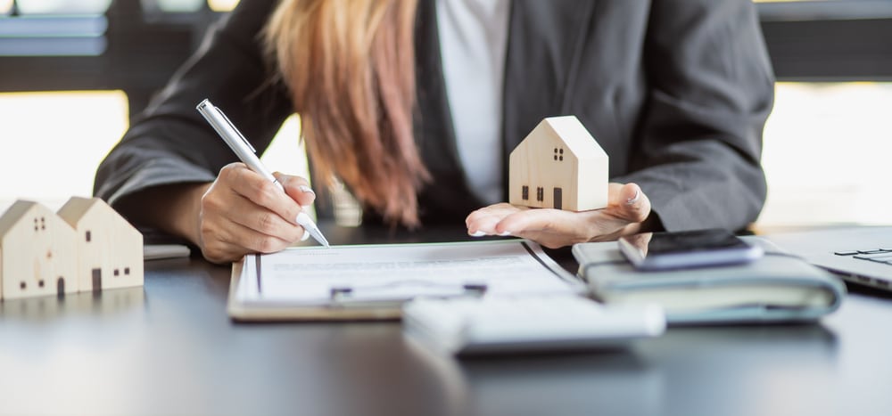 Woman holding model home